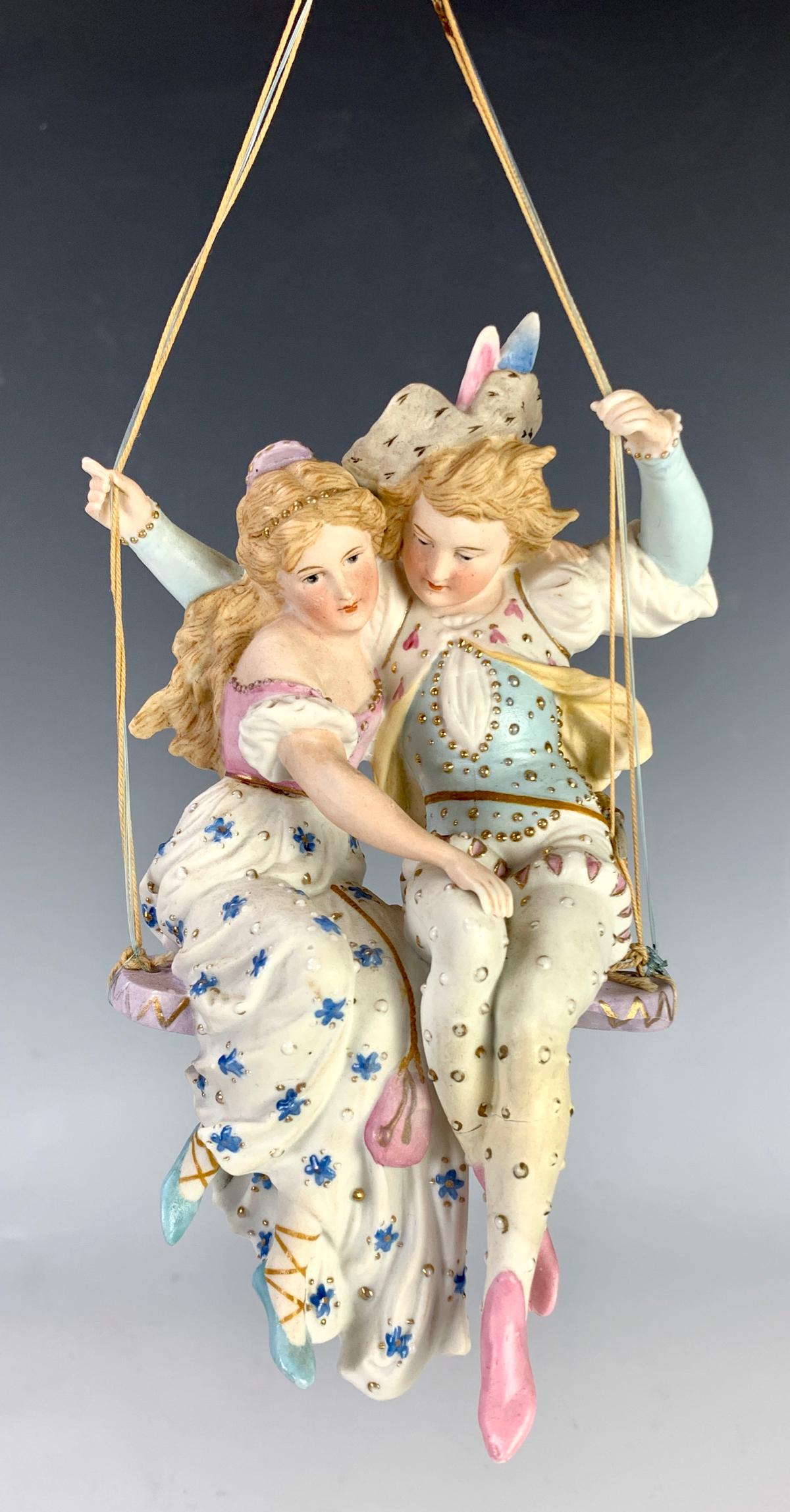 Bisque Couple Swinging Inside Glass Dome: Late 19th century, most likely German, dome not old, very good condition, 6" height, 12.5" height with glass dome *Private collection of a Los Angeles collector.