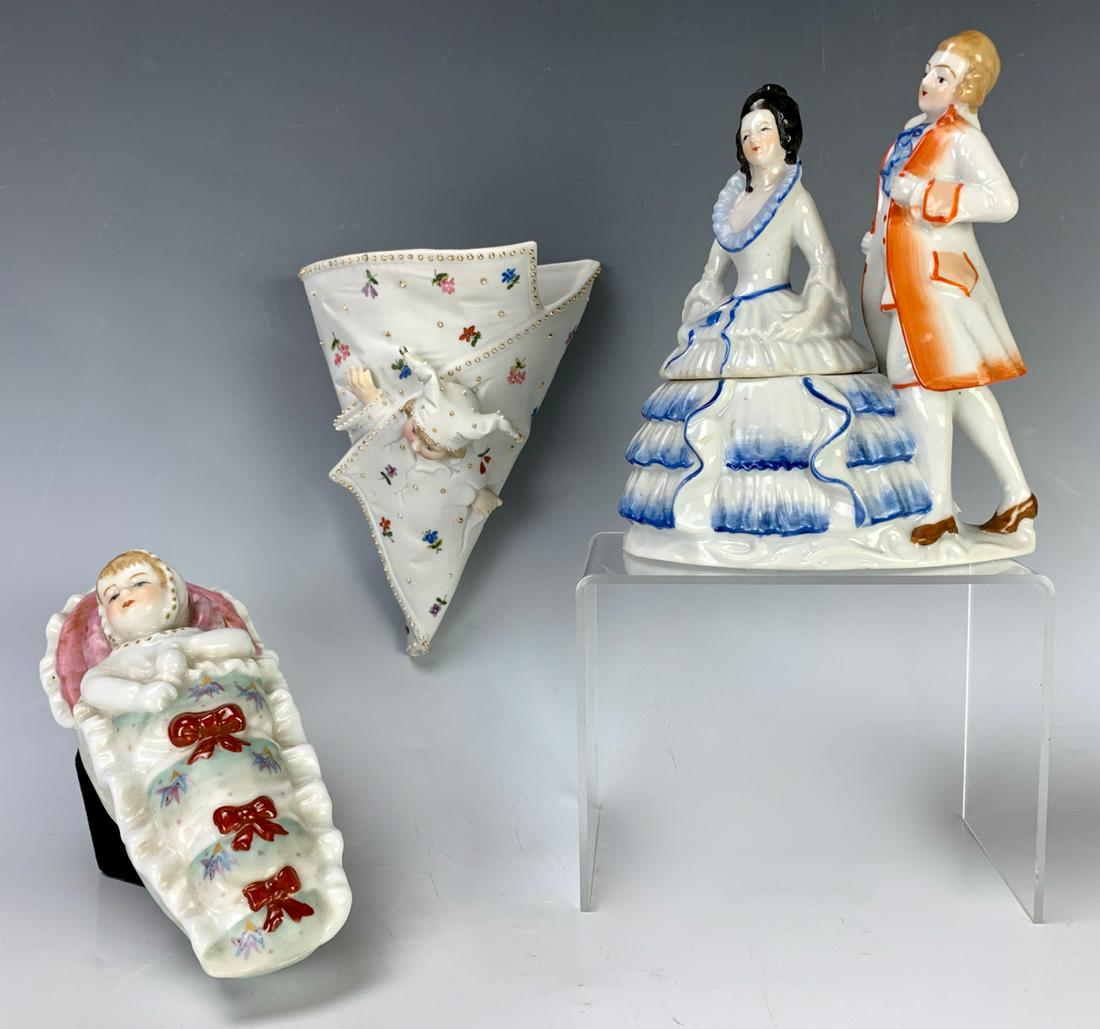 3 Porcelain Objects Including a KPM Wall Pocket: Circa 1900, having 3 porcelain objects, one being a signed figural KPM wall pocket, a porcelain couple with removable lid and a sleeping baby lidded box, very good condition, 7" longest *Private colle