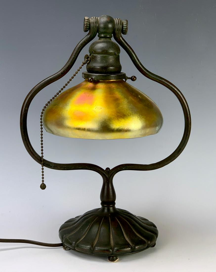 Tiffany Studios Desk Lamp with Aurene Shade: Tiffany Studios New York harp desk lamp with a Steuben aurene shade, base marked "Tiffany Studios, New York 419", shade signed with Steuben mark, good condition, cushion foot missing, missing plug, 13