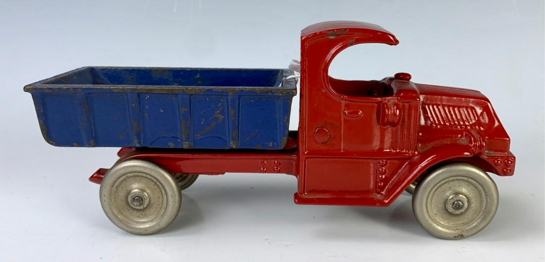 Vintage Champion Cast Iron Mack Toy Truck: Cast iron red C Mack cab and frame with blue dump body, nickel disc wheels, very good condition, slight wear to paint, 8" length