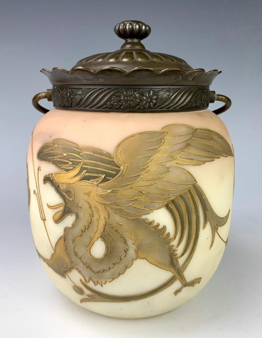Mount Washington Pairpoint Biscuit Jar: Having a mythological griffin decorated glass jar in the style of Royal Flemish, silver plate lid marked with Pairpoint Mfg. Co. logo and "4400", good condition, silverplate worn, 7" x 5"