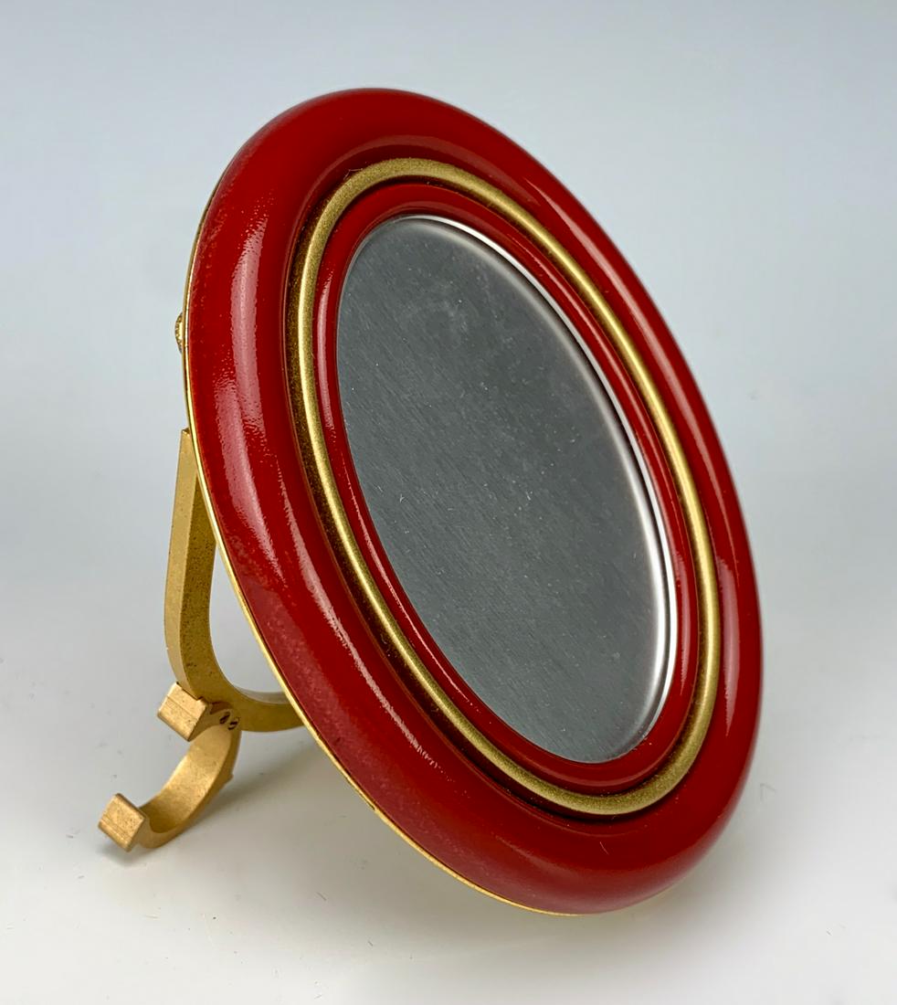 Cartier "Les Must" Picture Frame: Les Must Cartier picture frame in deep red color, having a gold gilt back and support, marked on back "Les Must de Cartier Paris" and numbered, very good condition, 3.5" x 3"