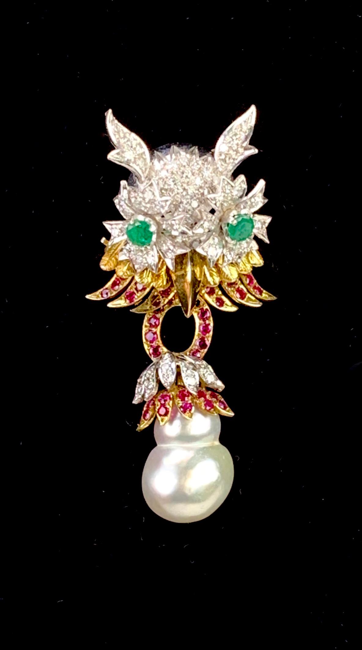 18K Gold Diamond Emerald Ruby Natural Pearl Owl Pin: Fabulous 18K (marked) yellow and white gold brooch modeled as an owl with encrusted diamond head, faceted emerald eyes, and ruby accents, suspended from owl is a natural pearl with ruby, diamond and g