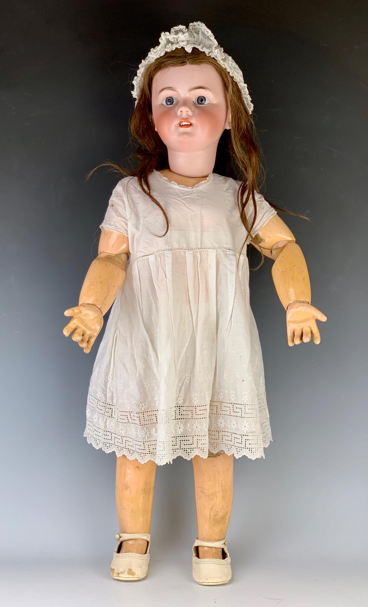 31" French Tete Jumeau Doll C. 1899: Open mouth with teeth, reset blue glass eyes (not sleep eyes), bisque head marked "Tete Jumeau" in red ink and incised "14", French composition and wood body with "Bebe Jumeau Diplome D'honneur" stick