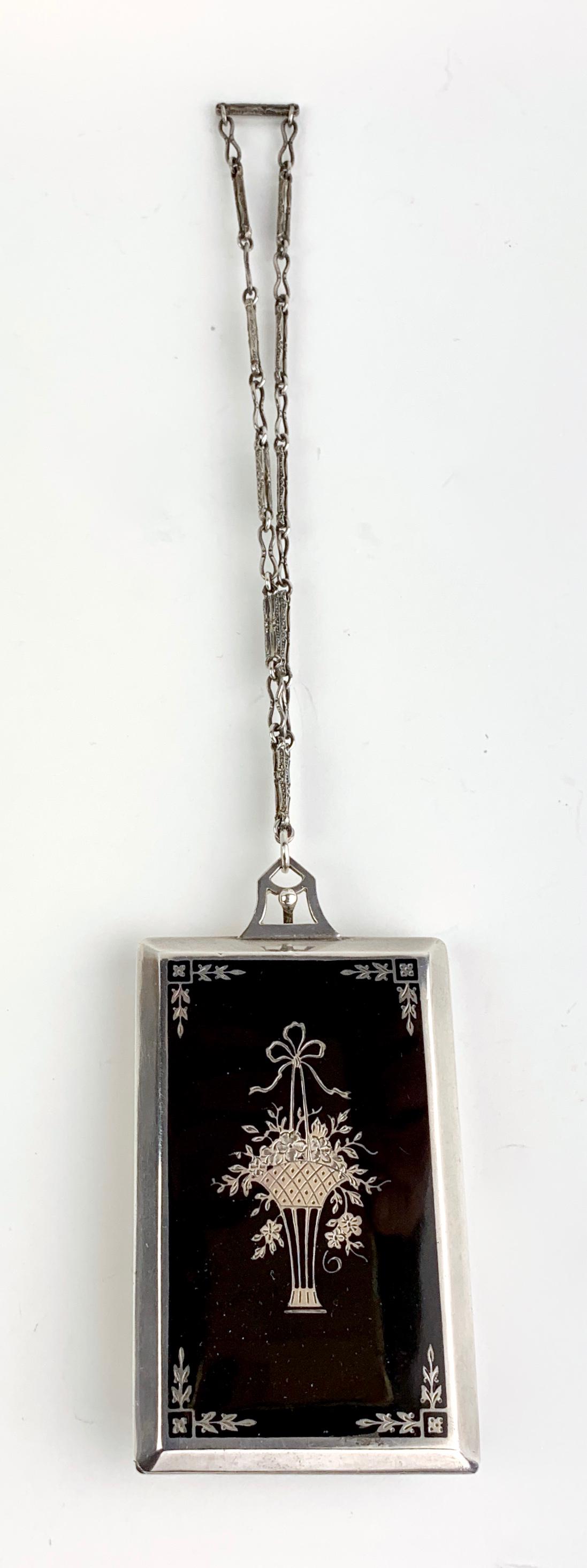 W&S Blackinton Co. Sterling & Enamel Compact: Circa 1920, beautiful sterling silver compact with black enamel having a basket of flowers etched, inside it has an oval mirror with 2 powder puffs, marked "Sterling", hallmarked "1,236", comes with c