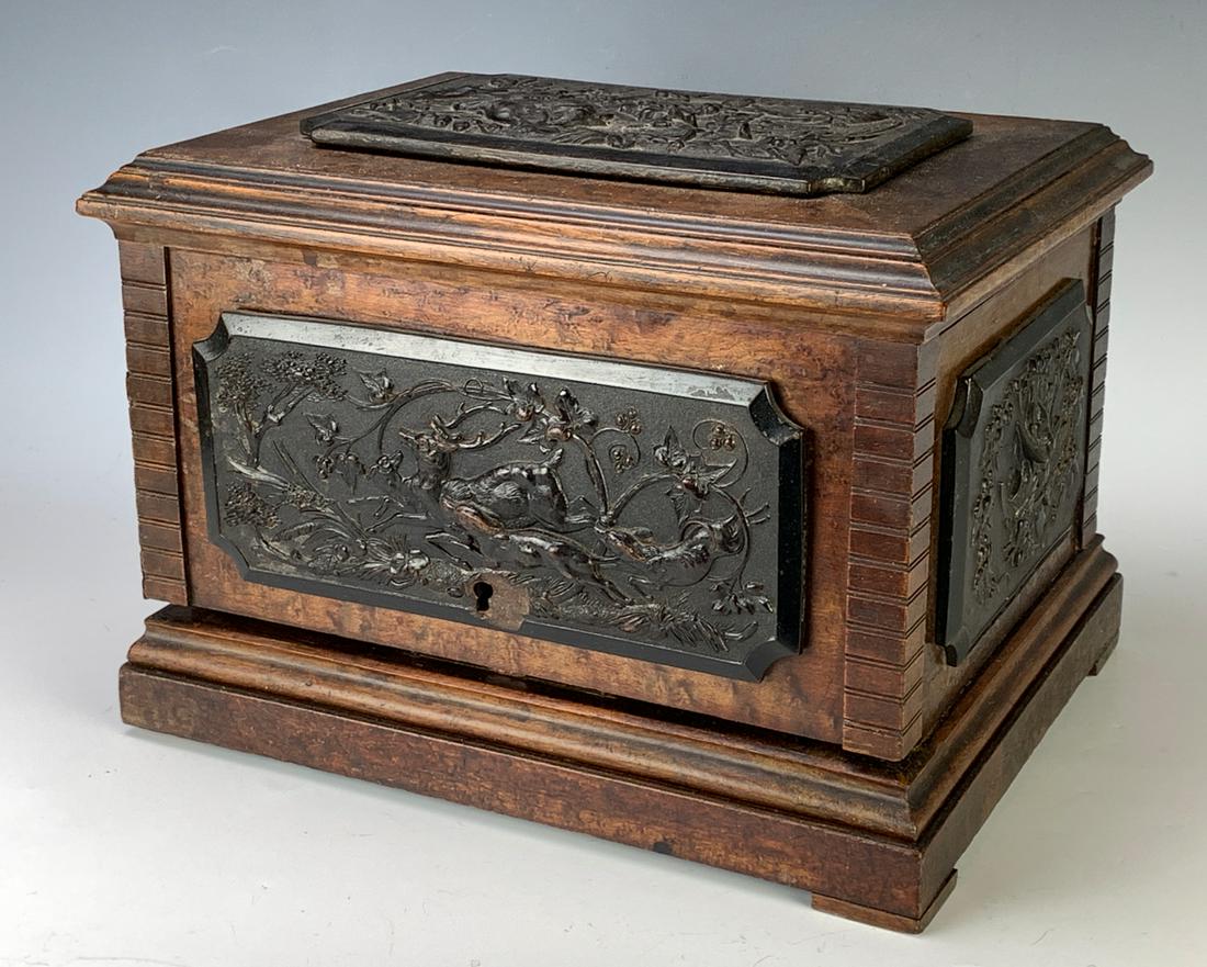 Antique 5 Drawer Cigar Cabinet Sgd. Tahan: Believed to be walnut with carved ebony panels decorating the top, sides and front with hunt scenes, retailed in Paris by Tahan, front ebonized pane has small chunk missing near keyhole, trays slightl