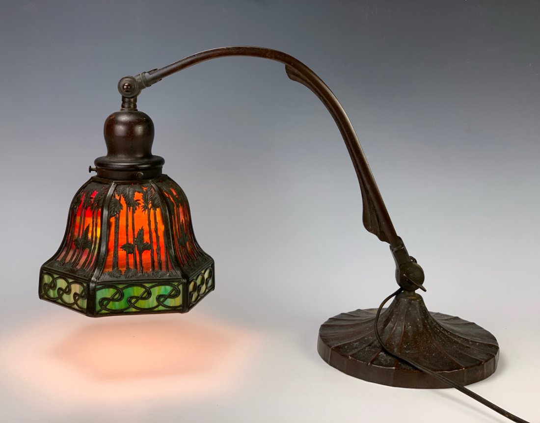 Signed Handel Overlay "Sunset Palm" Desk Lamp: Signed Handel overlay tropical design with palm trees on shade, double adjustable knuckle base, shade and base signed "Handel", good condition, 17" height *Wiring should be inspected before use*