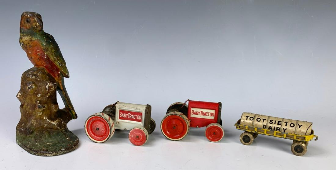 2 Vintage 1916 Baby Tractor & Tootsie Tin Toys: Includes 2 tin baby tractors, Tootsie tin toy and cast iron parakeet doorstop, good condition, 7" tallest