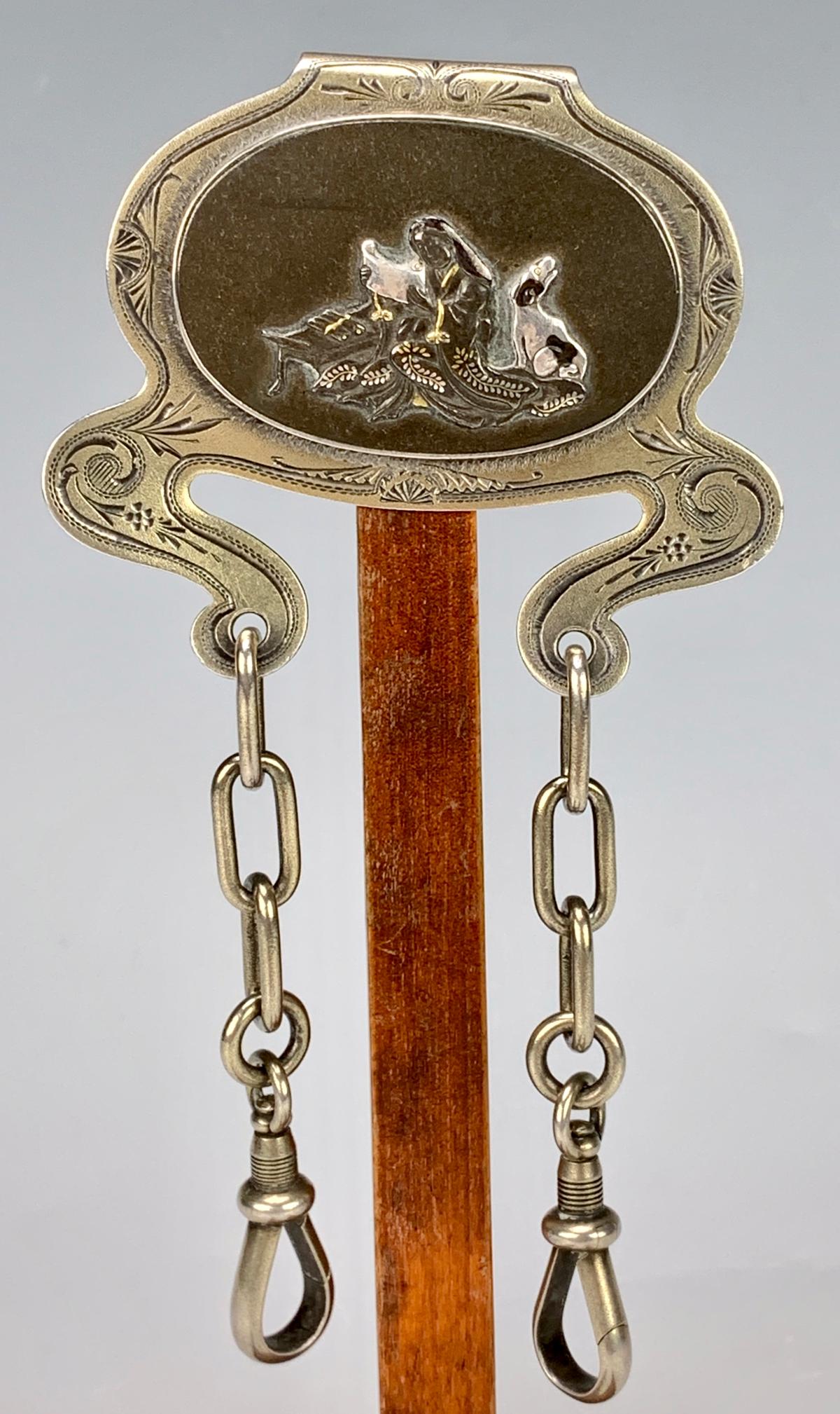Tiffany & Co. Sterling Mixed Metals Chatelaine: Circa 1870, rare watch chatelaine in mixed metals of sterling and bronze, oval bronze and silver Asian scene on a sterling back and 2 suspension clasps, signed "Tiffany & Co. Sterling "M" 1159 Union S