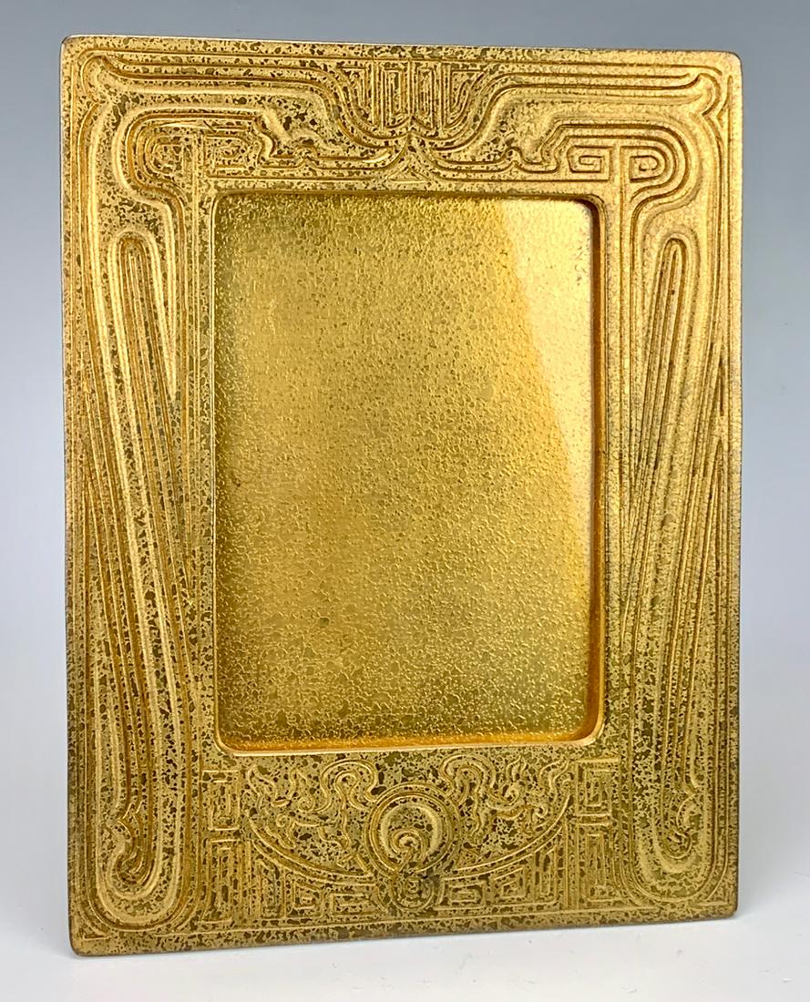 Signed Tiffany Studios "Chinese" Frame: Gilt bronze frame in the "Chinese" pattern, signed "Tiffany Studios, New York 1761", good condition, 8.75" x 6.625"