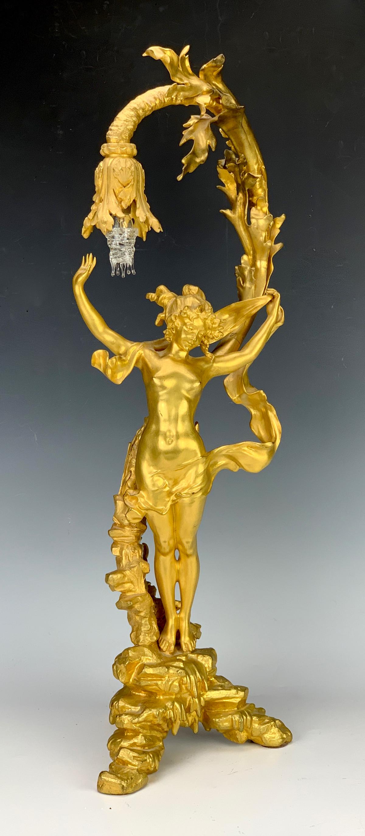 Charles Ferville-Suan(1847-1925) Art Nouveau Lamp: Charles Georges Ferville-Suan (France 1847-1925), stunning gild gilt bronze representing a nude woman playing with a piece of fabric on a tripod base carved with rocks, signed at the base, very good c