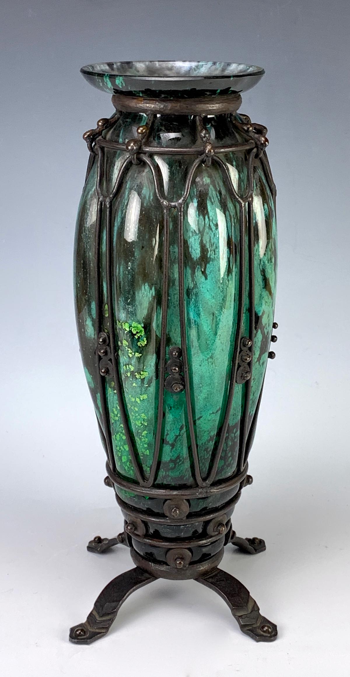Daum Nancy Majorelle Signed w/ Iron Mounting: Circa 1920 France, stunning art deco vase with green mottled glass encased in an ornate iron frame and 4 iron feet, signed on glass "Daum Nancy" and "Majorelle (Louis)", very good condition, 13.5" hei
