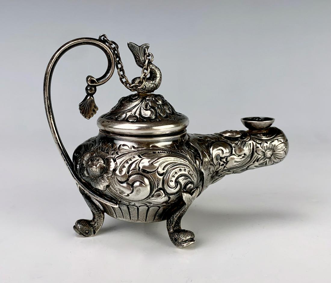 Ornate Sterling Repousse Cigar Lighter C. 1900: Having beautiful ornate repousse cigar lighter with a dolphin finial and dolphin feet, marked on bottom "Sterling 25" with maker's logo, 64 grams, 2.05 troy ounces, very good condition, tarnished, 2.5