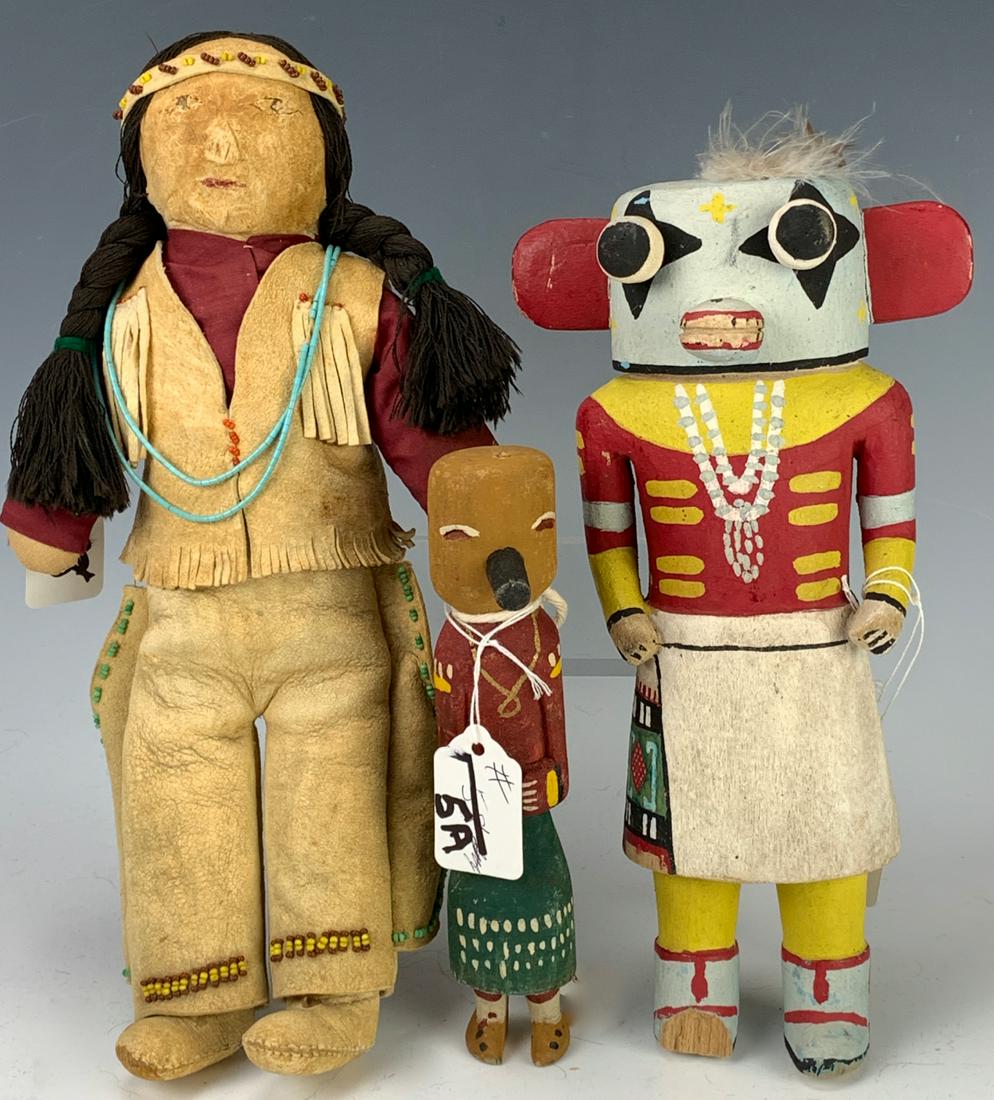 Three Native American Dolls: 12" one of leather, suede and cloth, two 10" carved wood Kachina Indians, larger one has broken foot, fair to good condition