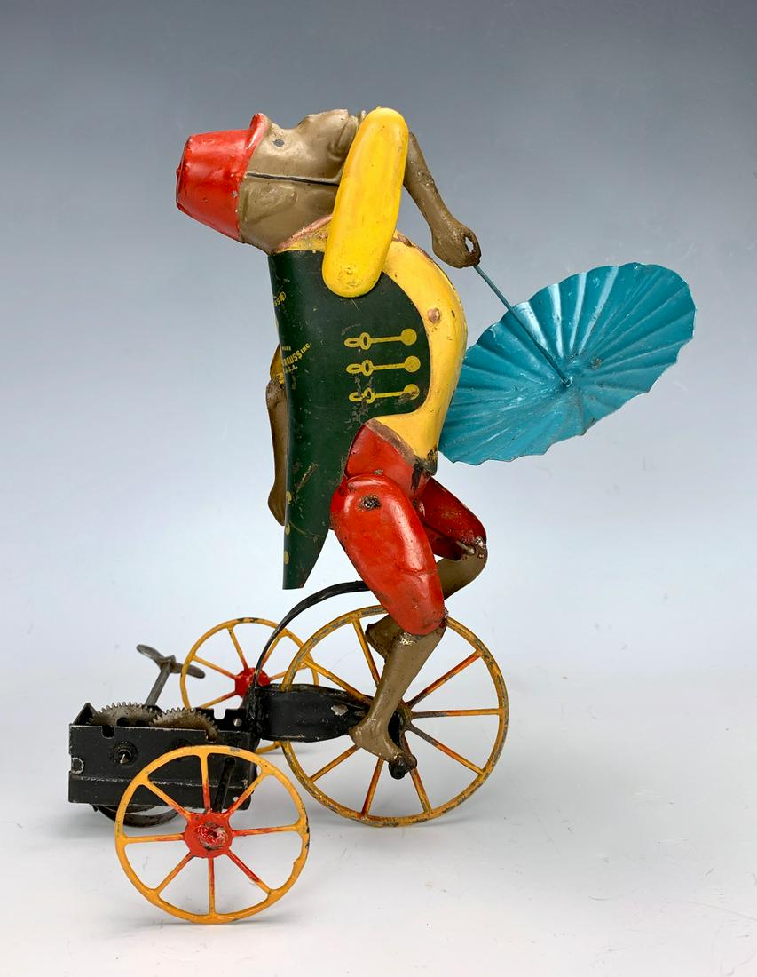 Ferdinand Strauss Clockwork Monkey on Tricycle: Ferdinand Strauss clockwork monkey on tricycle, made in America by the Ferdinand Strauss Company in New York, depicts a monkey with an umbrella riding a tricycle, very good condition, 8" height *Mecha