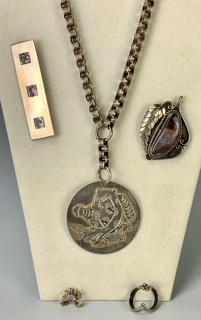 Group of Native American Jewelry: Consisting of a pendant with jasper stone and sterling silver, necklace with chain and Aztec design, rectangular brooch with mother of pearl squares and 2 pairs of earrings, assorted marks, good condi