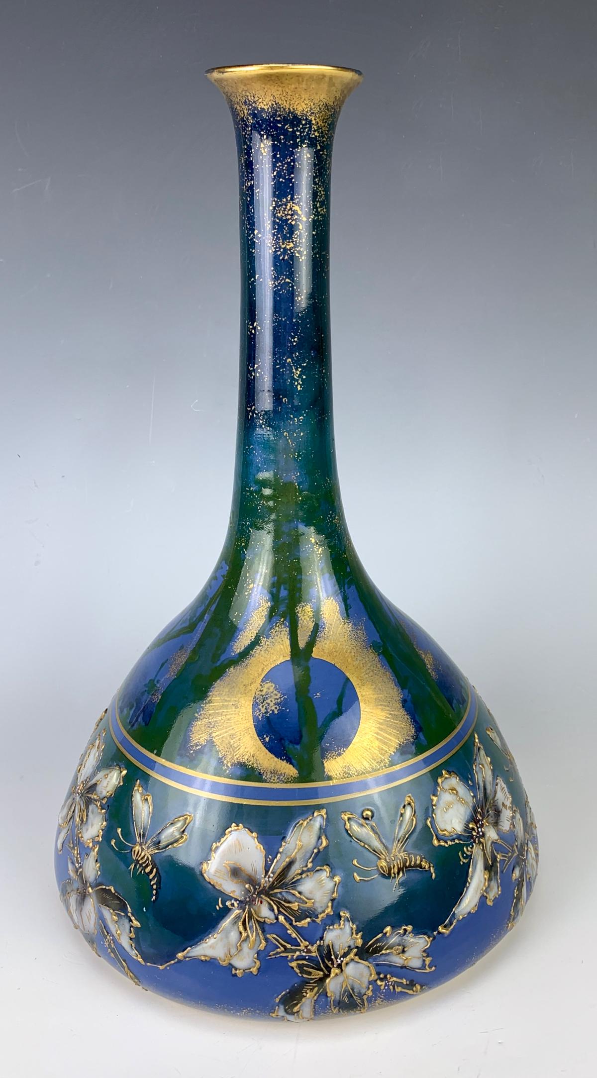 Amphora RSTK Bees and Flowers Vase: Circa 1900, made of porcelain, having a high glaze body in blues, bottom band has raised gilt bees amongst flowers and the upper half shows a moon amongst the trees, signed with the Amphora red mark "