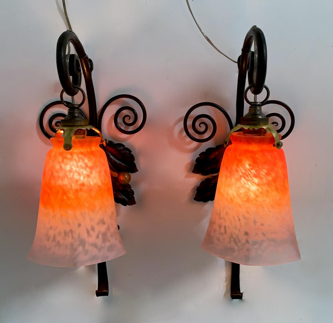 Pair of Art Deco Wall Sconces Signed Schneider: Circa 1920, pair of wrought iron wall scones with leaves and cherries, pair of signed Schneider mottled glass shades in orange graduated to a translucent pink, very good condition, has been electrifie