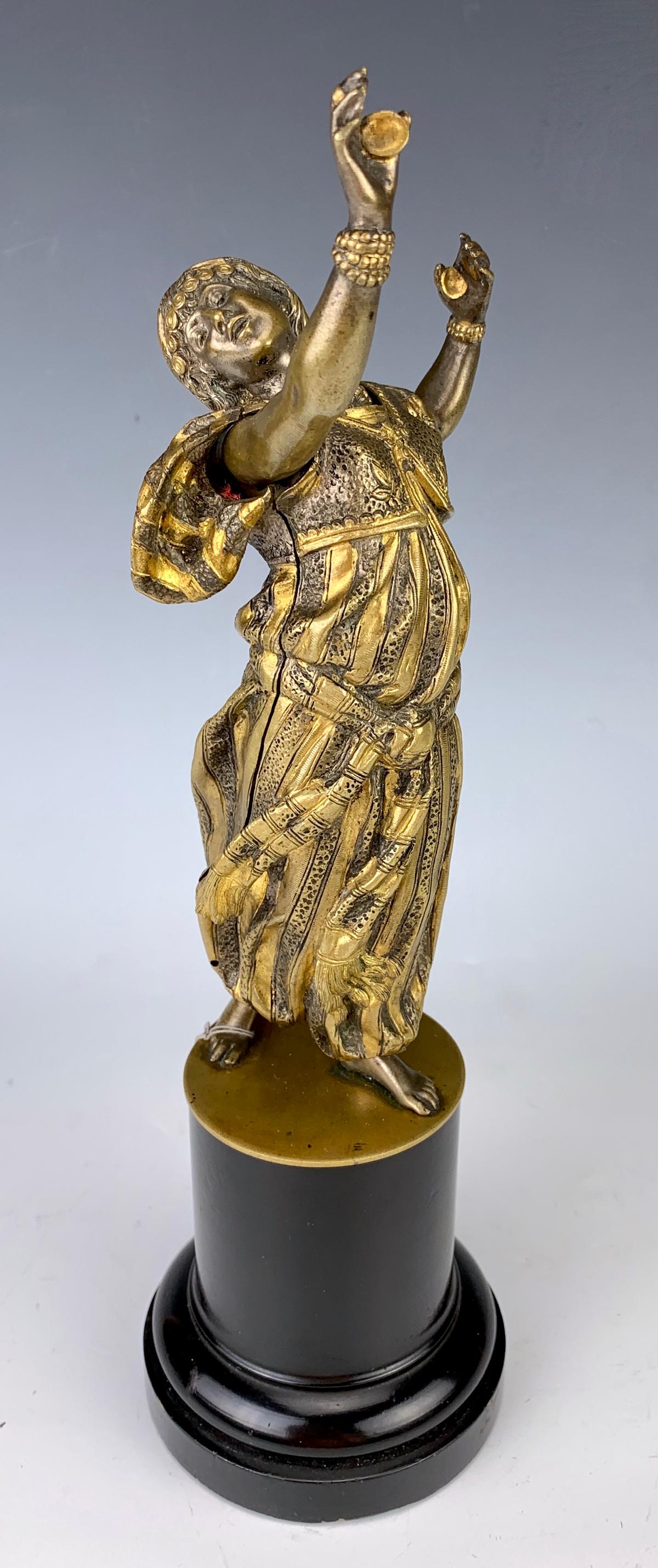 Attr: Bruno Zach Erotic Orientalist Mech. Bronze: Circa 1880, attributed to Bruno Zach erotic orientalist mechanical bronze, having a 2 tone (gilt and silvered) bronze figure of a robed orientalist woman dancing and playing with castanets, when pin i