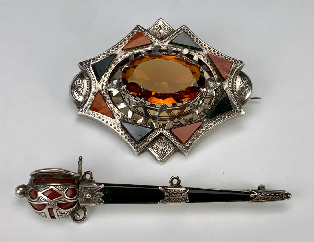 Two Scottish Silver Jewelry Pins, One with Citrine: This lot includes 2 Scottish silver and stone jewelry pins, one having a large citrine mounted in an agate and silver mount, other is a sword type pin, both unmarked, good condition, 2" x 1.5" agate