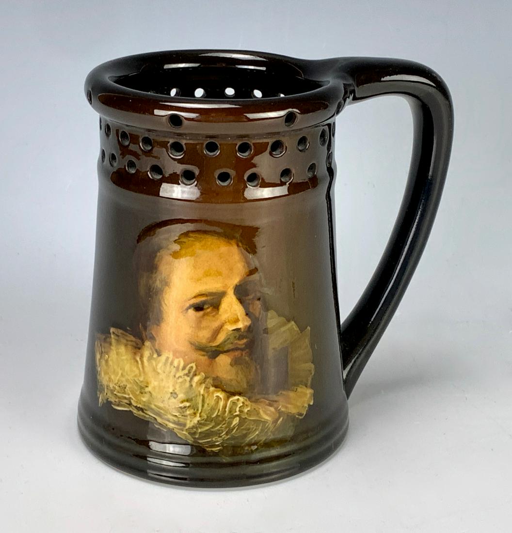 Rookwood Portrait Puzzle Mug - Shakespeare (?): Having a standard glaze, has artist's initials and marked with Rookwood flame mark and "711", painted portrait of possibly William Shakespeare, good condition, 5" height
