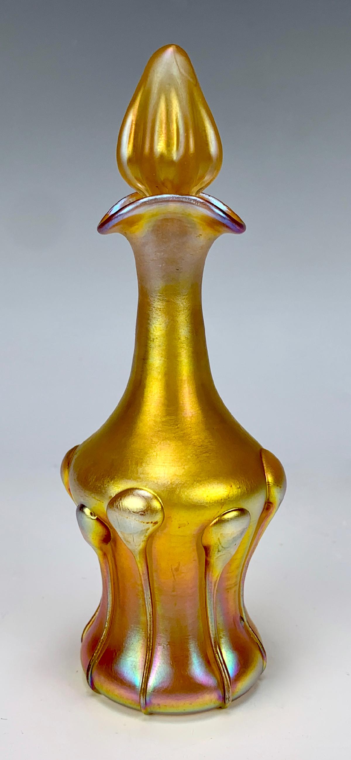 Tiffany Studios Favrile Perfume Bottle: Signed ÒL.C. Tiffany Favrile 4492HÓ, gold iridescent bottle with tadpole tendrils, all original, very good condition, 5.5" height, 2" diameter