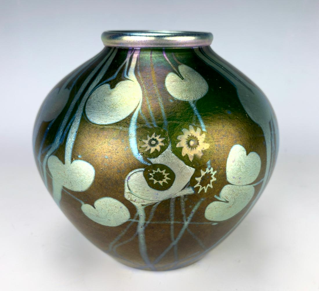 Tiffany Studios Dark Green Millefiori Vase: Tiffany Studios dark green millefiori vase, favrile glass vase is decorated with a dark green iridescent background, having silver leaf and vine pattern and groupings of millefiori cane flowers, has b