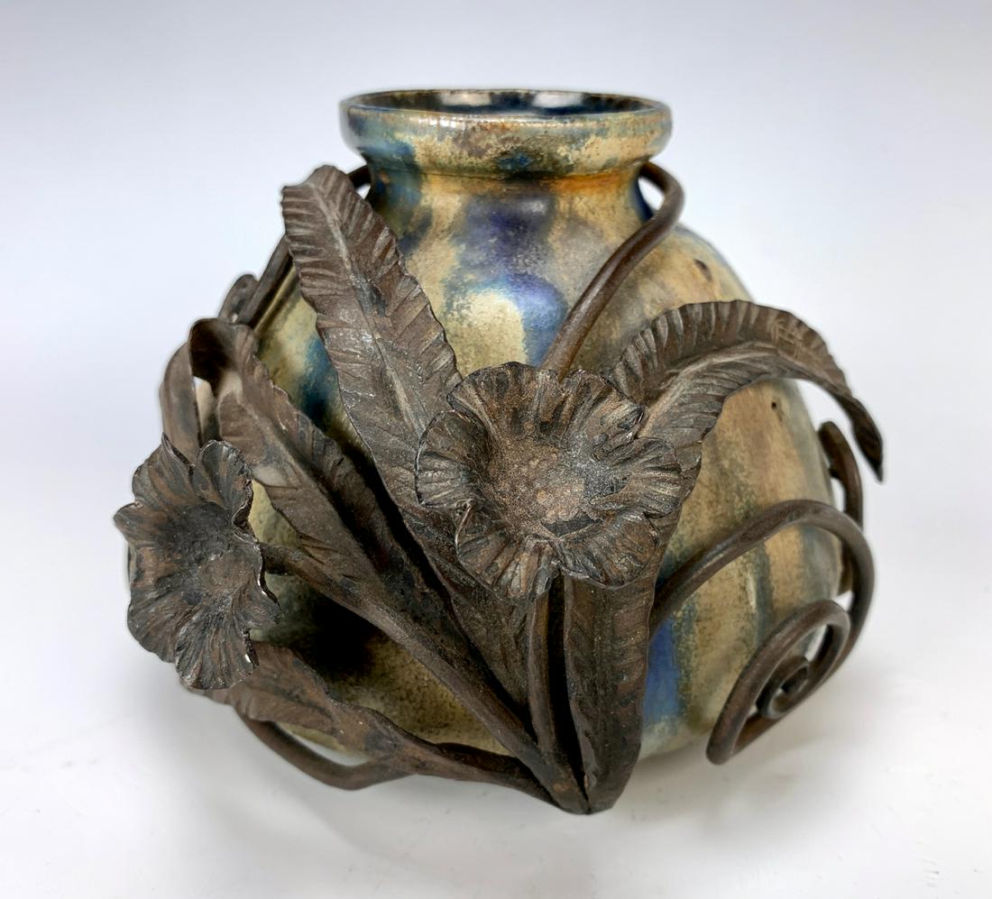 Guerin & Carion Pottery & Iron Mount Vase: Guerin blue and brown crystalline vase encased by a hand wrought iron leaves and flowers, the base is signed "Guerin 033" and the iron work is signed "E. Carion", made in Belgium, very good condition,