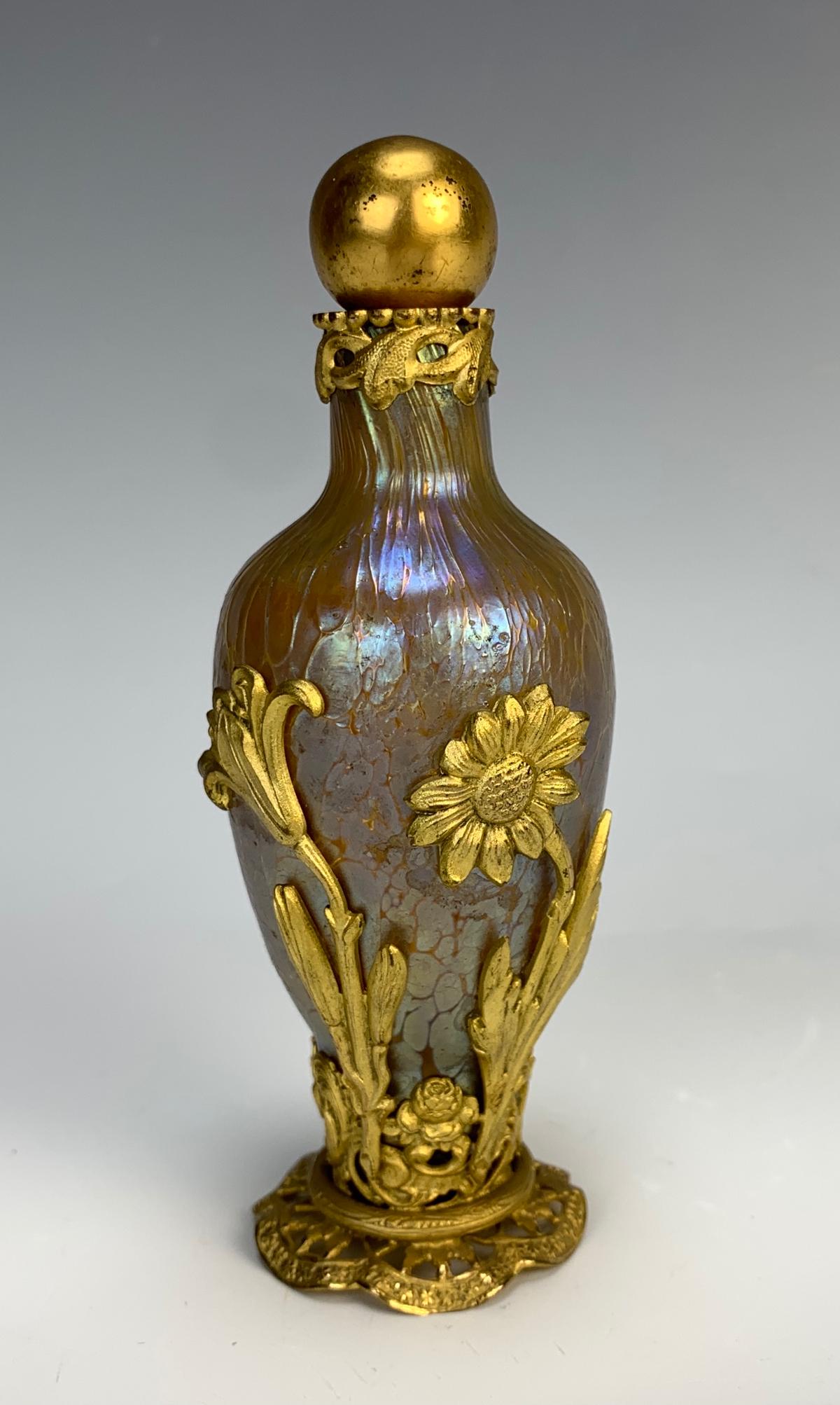 Rare Loetz Art Nouveau & Gilt Bronze Perfume: Circa 1900, rare find, Loetz glass bottle with are nouveau flowers and ornate pierced carved base, has original ball stopper, good condition, cork slightly worn, 5" height