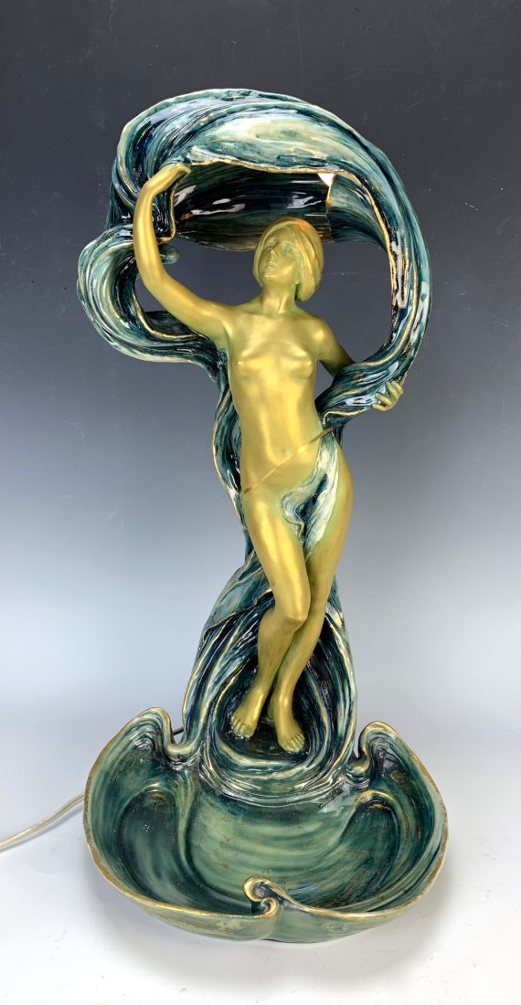 Ernst Wahliss Art Nouveau Nude Figural Lamp: Circa 1900, wonderful art nouveau porcelain nude figural lamp, depicts a lady nude, gold gilded against a green wavy scarf where a lamp is hidden and matching green vide a poche base, signed with Erns