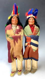 Group of 2 American Indian Skookum Dolls: Group of 2 American Indian Skookum dolls. All with vibrantly colored feather head dresses. Tallest 16".Very good condition.. Lifetime Collection of Sharon McDowell, Simi Valley, CA