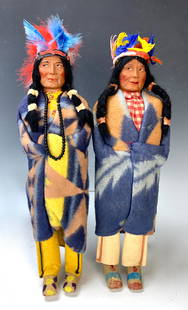 Group of 2 American Indian Skookum Dolls: Group of 2 American Indian Skookum Dolls. Doll with light blue feathers is marked under foot. Tallest 16 1/2". Very good condition. Lifetime Collection of Sharon McDowell, Simi Valley, CA