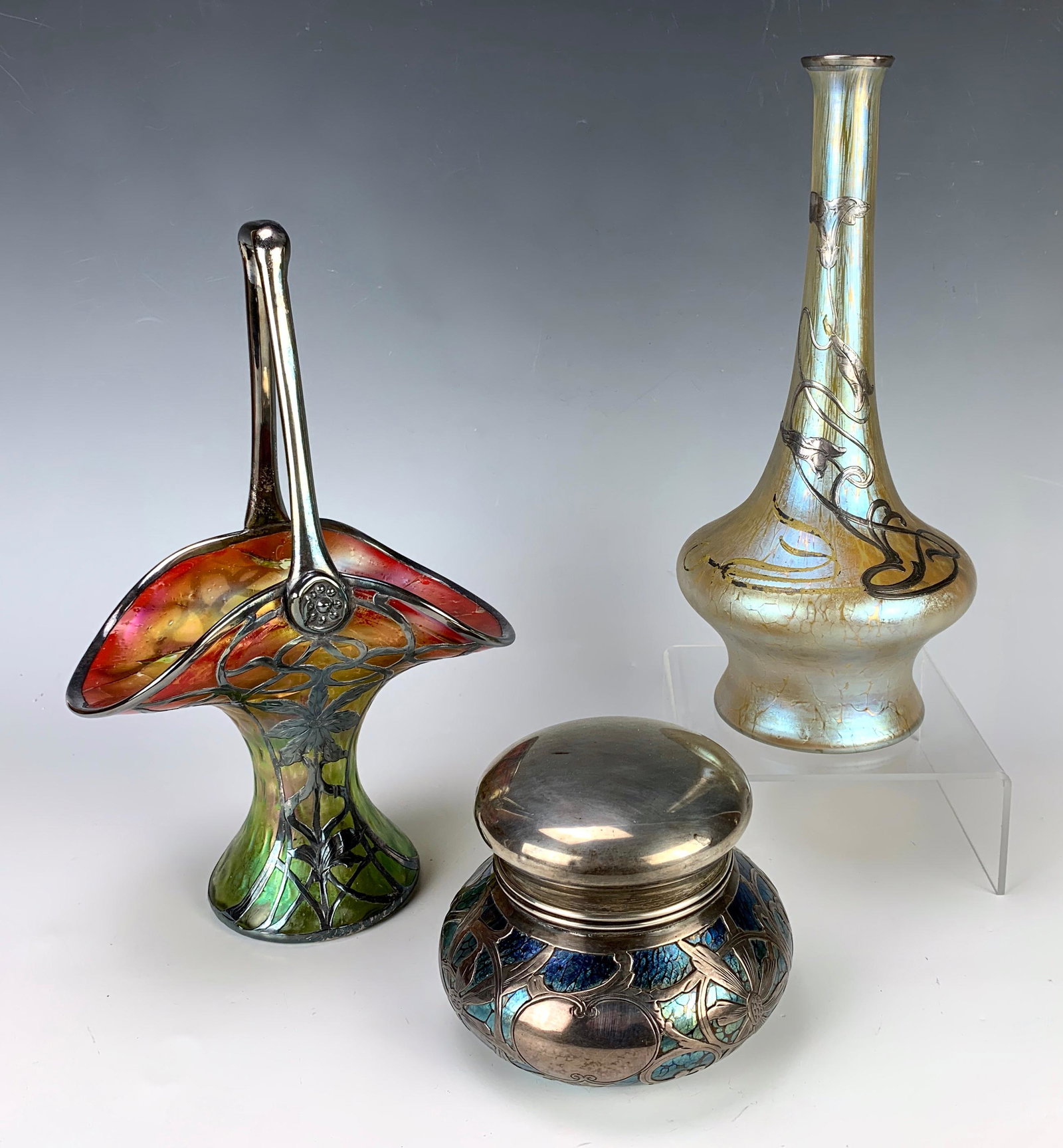 3 Loetz Silver Overlay Pieces: Circa 1900, three iridescent art glass pieces,two vases and lidded bowl all in sterling silver overlay, sold as is, all 3 have damage, 10.56" tallest