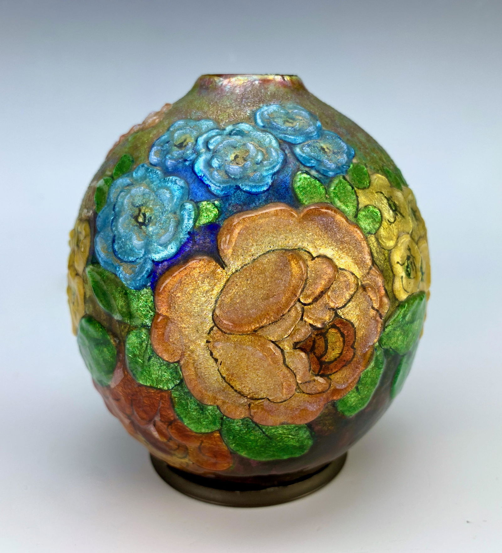 Camille Faure Art Deco Flowers Vase: Circa 1920, multi colored enamel over copper vase, having raised relief flowers in colors of yellow, blue, red and orange, signed in gilt "C. Faure Limoges", very good condition, 4.38" x 4"