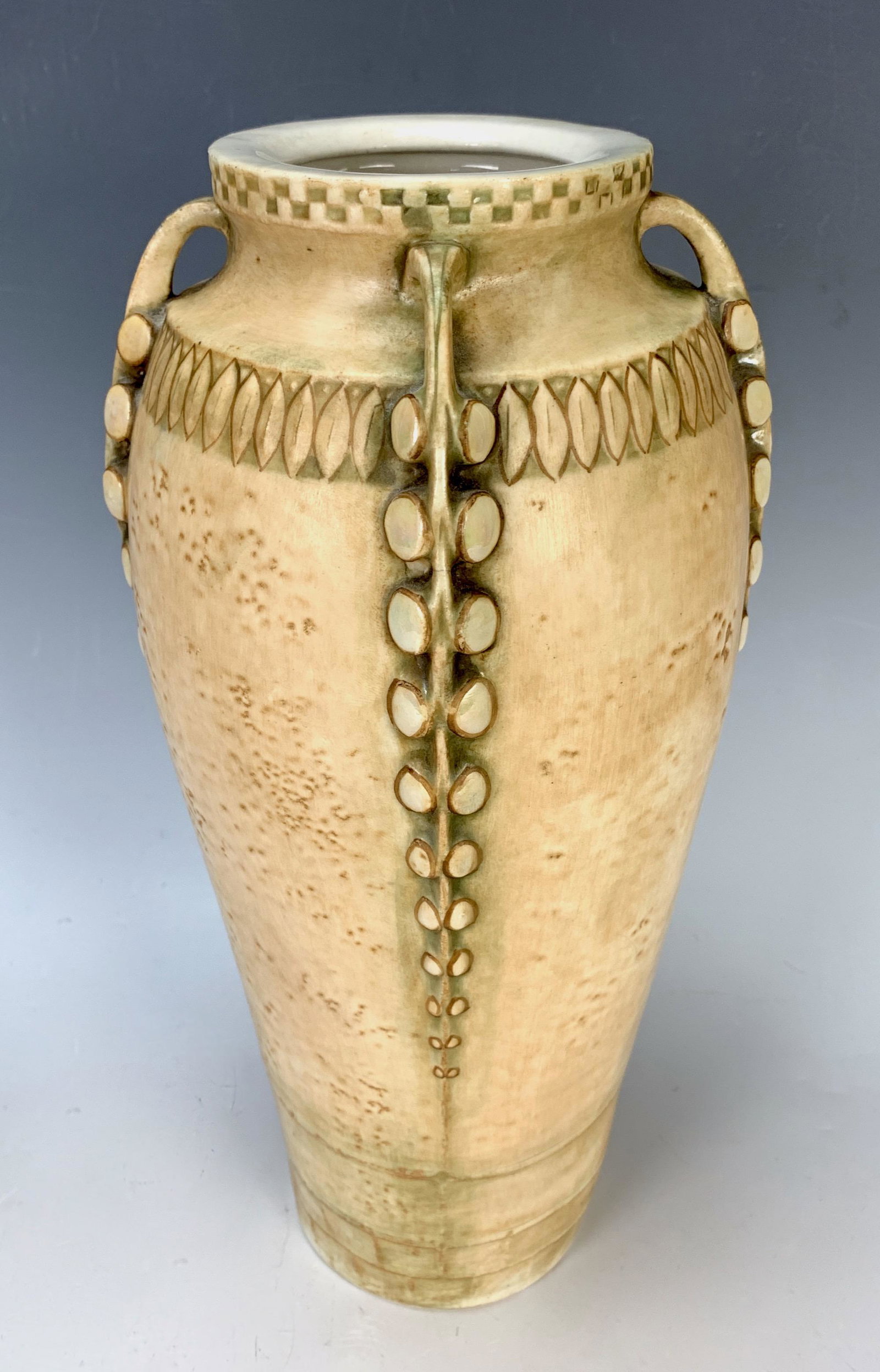 Paul Dachsel Art Nouveau Porcelain Vase: Circa 1900, a decorated cream colored porcelain vase with graduating double strands of flowers on four sides, pictured in Byron Vreeland's book "Monsters & Maidens", page 188, marked "Czechoslovakia 9