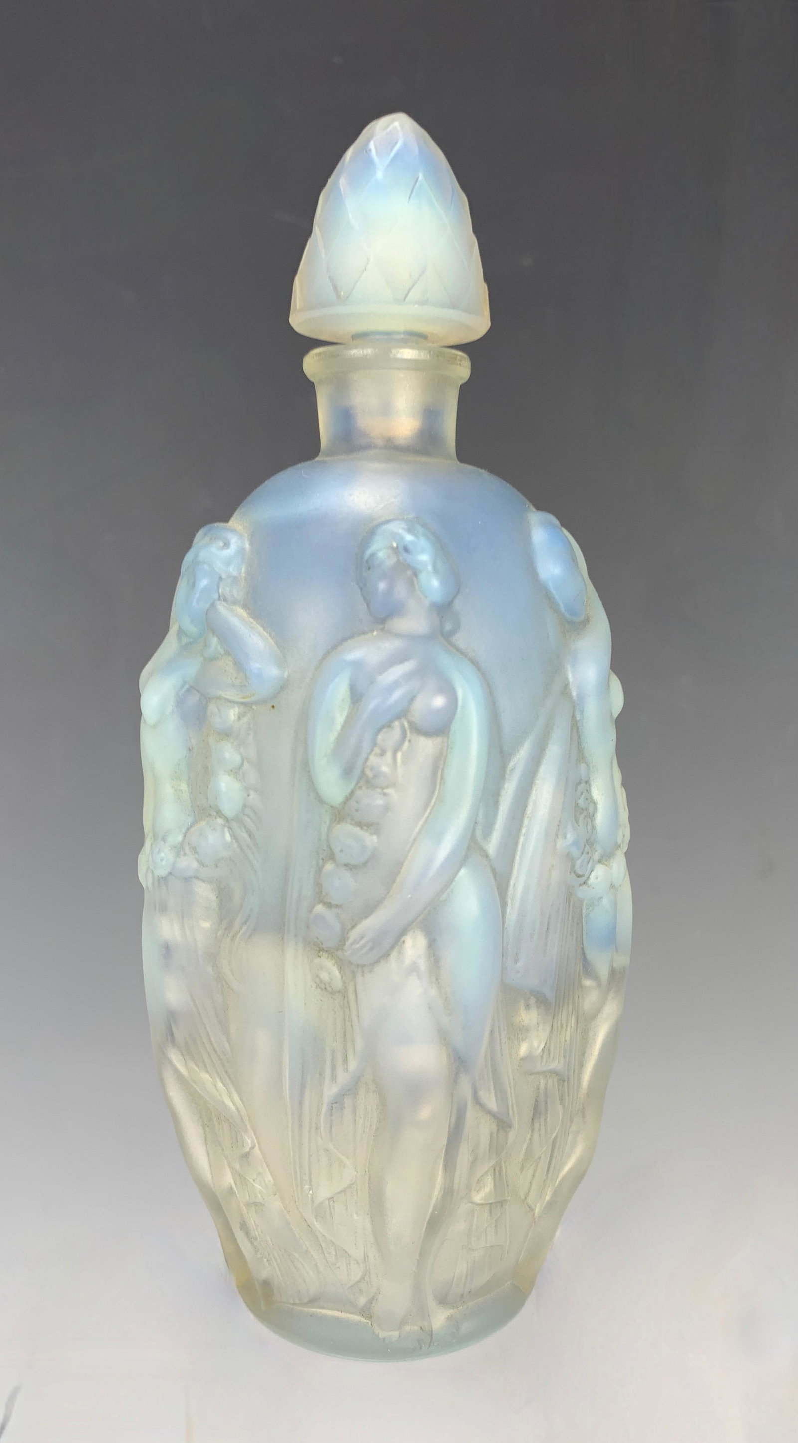 Sabino Four Seasons Perfume Bottle: A Sabino moulded opalescent art glass perfume bottle in Four Seasons pattern, signed "Sabino, Paris", very good condition, 15.2 cm