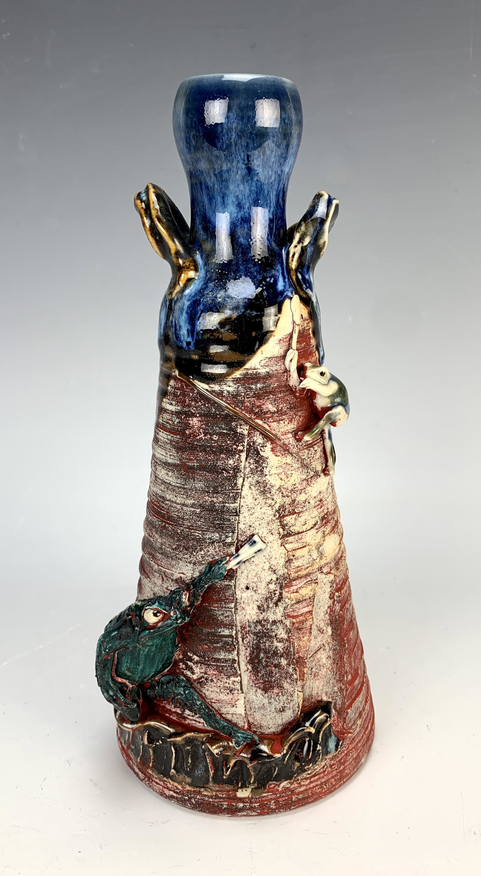 Sumidaware (Japanese) Happy Frogs Vase: Made of porcelain is this Japanese sumidaware vase depicting two frogs playing together on a horn shaped form. Signed with raised tag. 9.5" tall. Condition: slight paint wear on body, couple of string