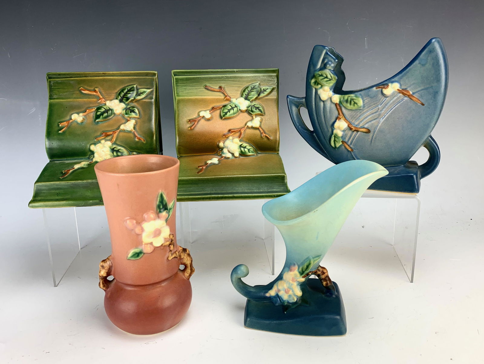 Group of 5 Roseville "Apple Blossom & Snowberry": Includes pair bookends, 2 vases and cornucopia. Late 1940's. 6" largest. Condition: good.