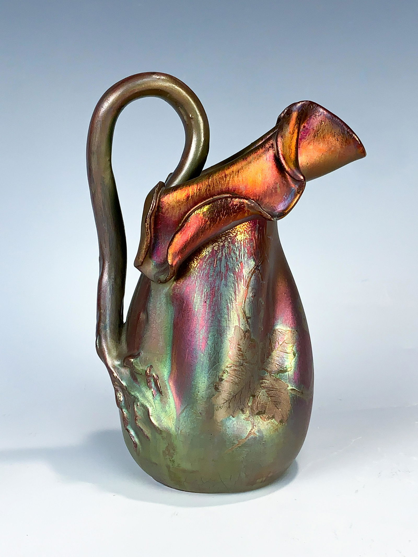 Jerome Massier (1850-1916) Art Nouveau Pitcher: Having a nice size Jerome Massier Fils earthenware iridescent pitcher from the Art Nouveau period, circa 1900. Colors of red and gold with decorations of leaves. Signed on bottom J Massier Fils (Sons)