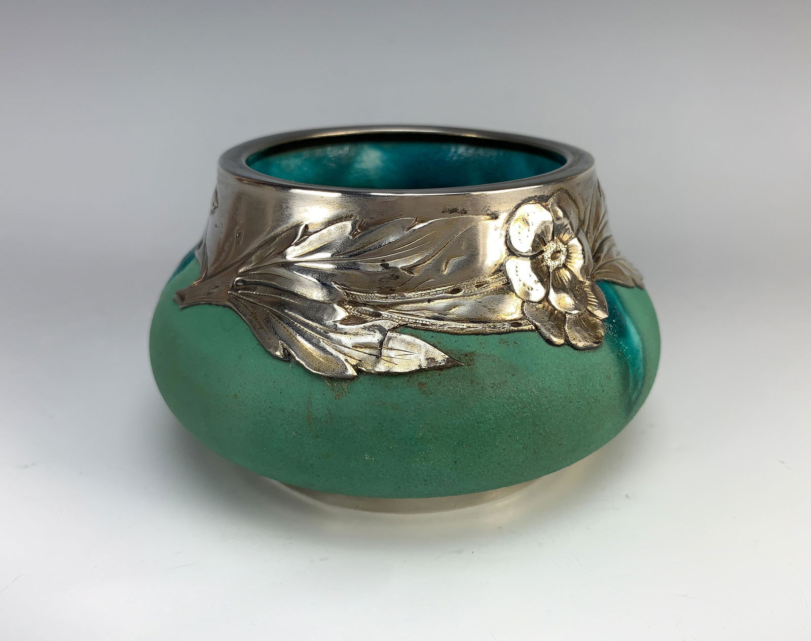 Rare Clement Massier Pottery Vase with Sterling: Late 19thC, having a rare Clement Massier pottery vase with a beautiful drip glaze in Turquoise, and having a raised leaf and flower collar in sterling, hallmarked. Has sterling foot. Impressed: Cleme