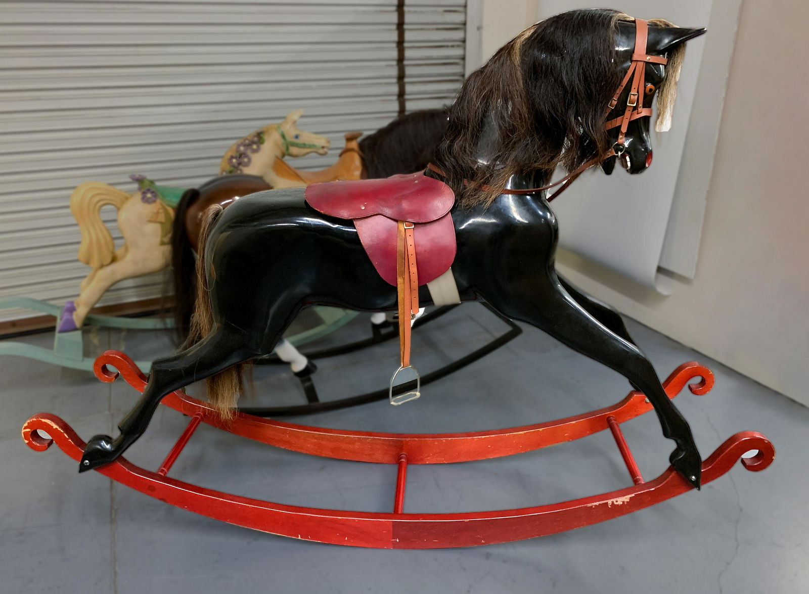 Vintage Haddon Black Fiberglass Oversized Rocking Horse: Made in England, 1970-1980. This beautiful horse has wooden rocker and a fiberglass body. It's strong enough for an adult to ride. Size: 36" seat height, 49" floor to top of head, 72" long bow. Very g