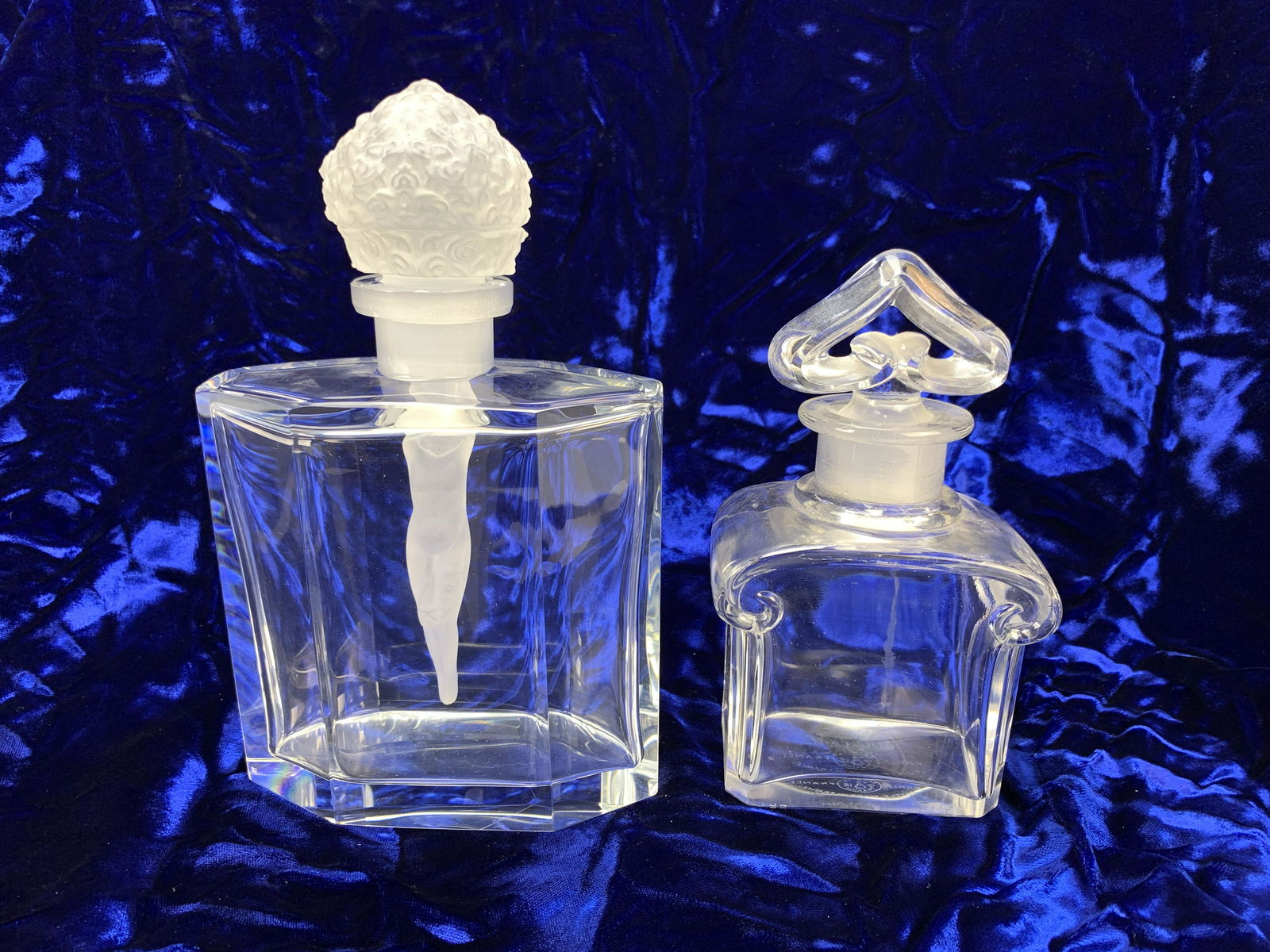 2 Perfume Bottles Baccarat & Nude Stopper: Lot of 2 perfume bottles, one signed Baccarat with logo, the other similar to a Hoffman with nude stopper-likely a newer copy, tallest 8", very good condition.Have a similar item to sell? Email us at