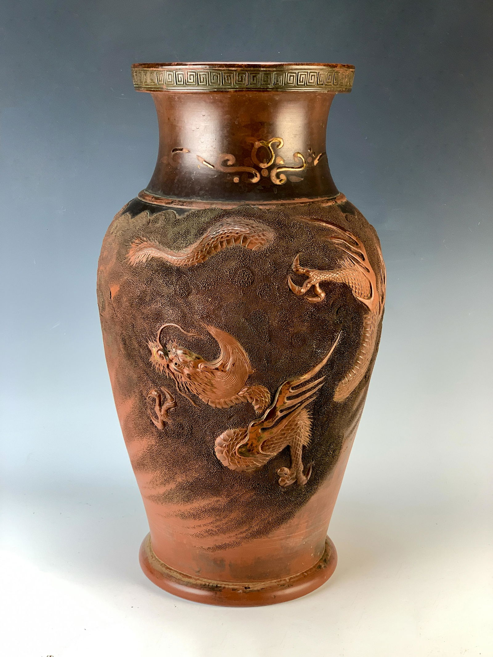 Large Japanese Redware Vase: A fine quality Japanese redware vase decorated with dragons in the clouds, in relief. Size: 19.5" tall. Condition: great age patina, hole drilled on bottom, slight damage at the very top with wear tod