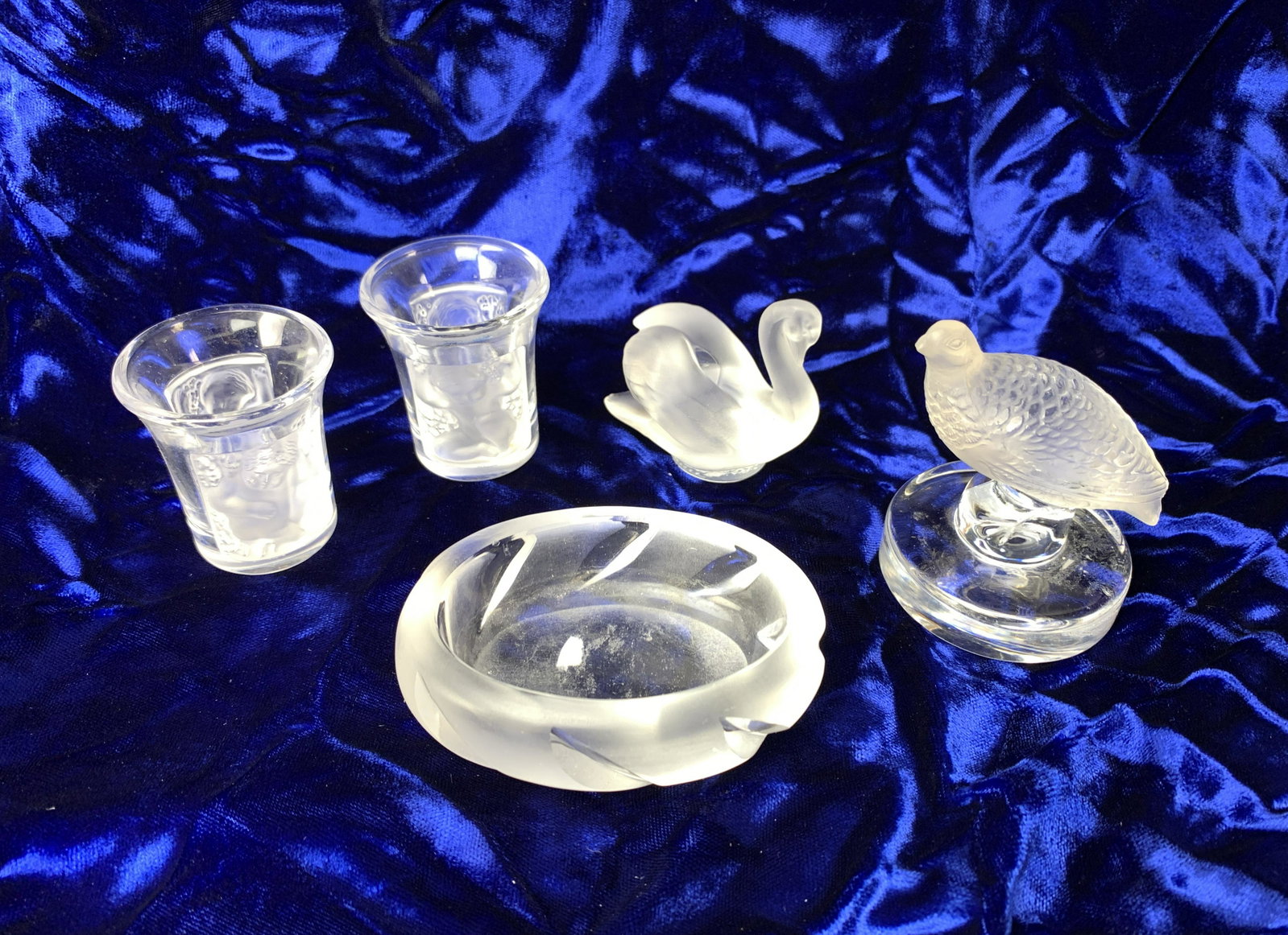 Group of 5 pcs, Signed Lalique: Lot of 5 includes 2 shot glasses, a small swan, a small quail and oval salt?, all signed, 3" largest, all very good condition. Have a similar item to sell? Email us at info@treasureseekerauction.com