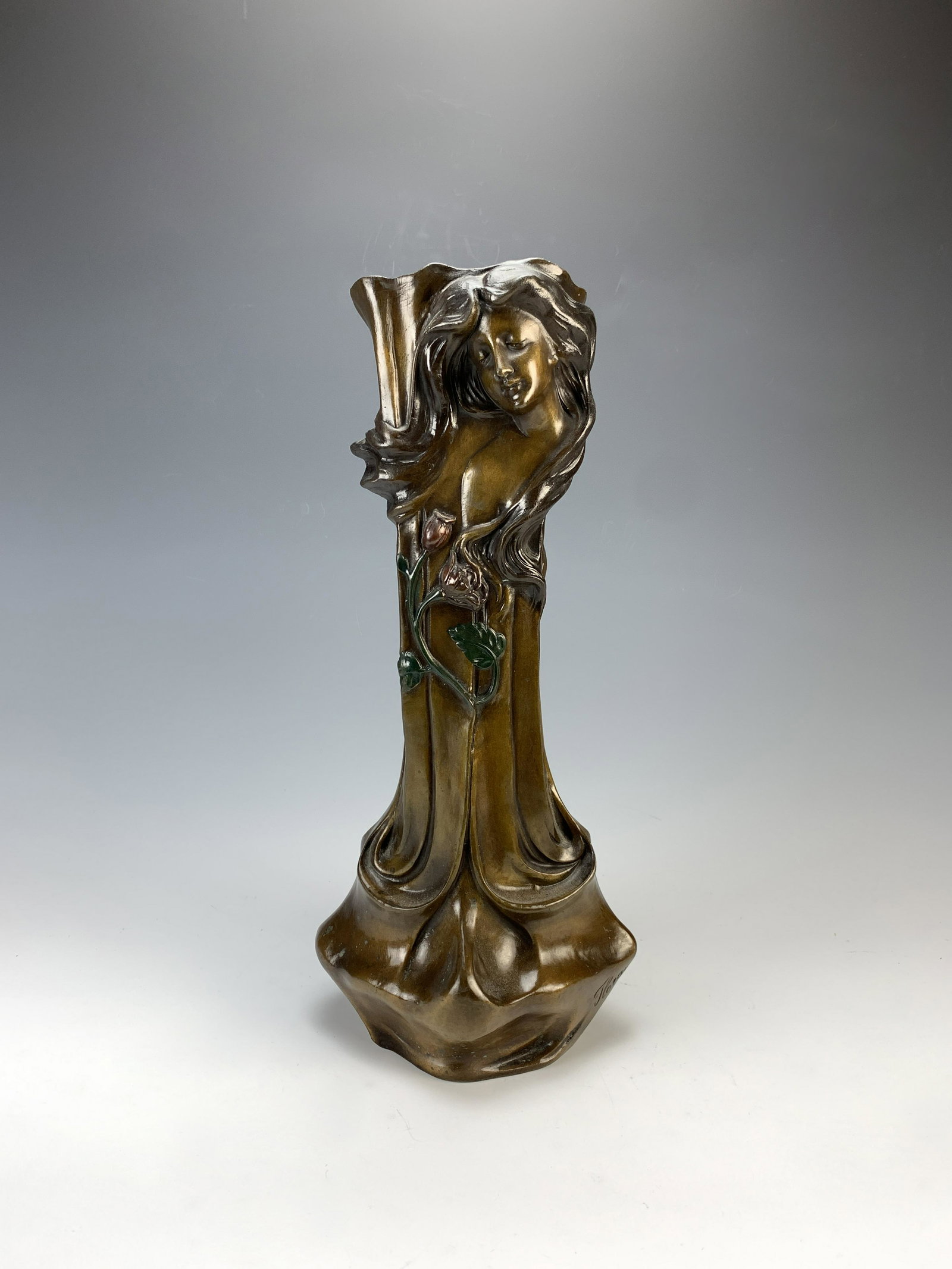 Art Nouveau Style Bronze Vase: A two toned patinated bronze vase with art nouveau style female faces at top, 16.5" tall, good condition. Have a similar item to sell? Email us at info@treasureseekerauction.com