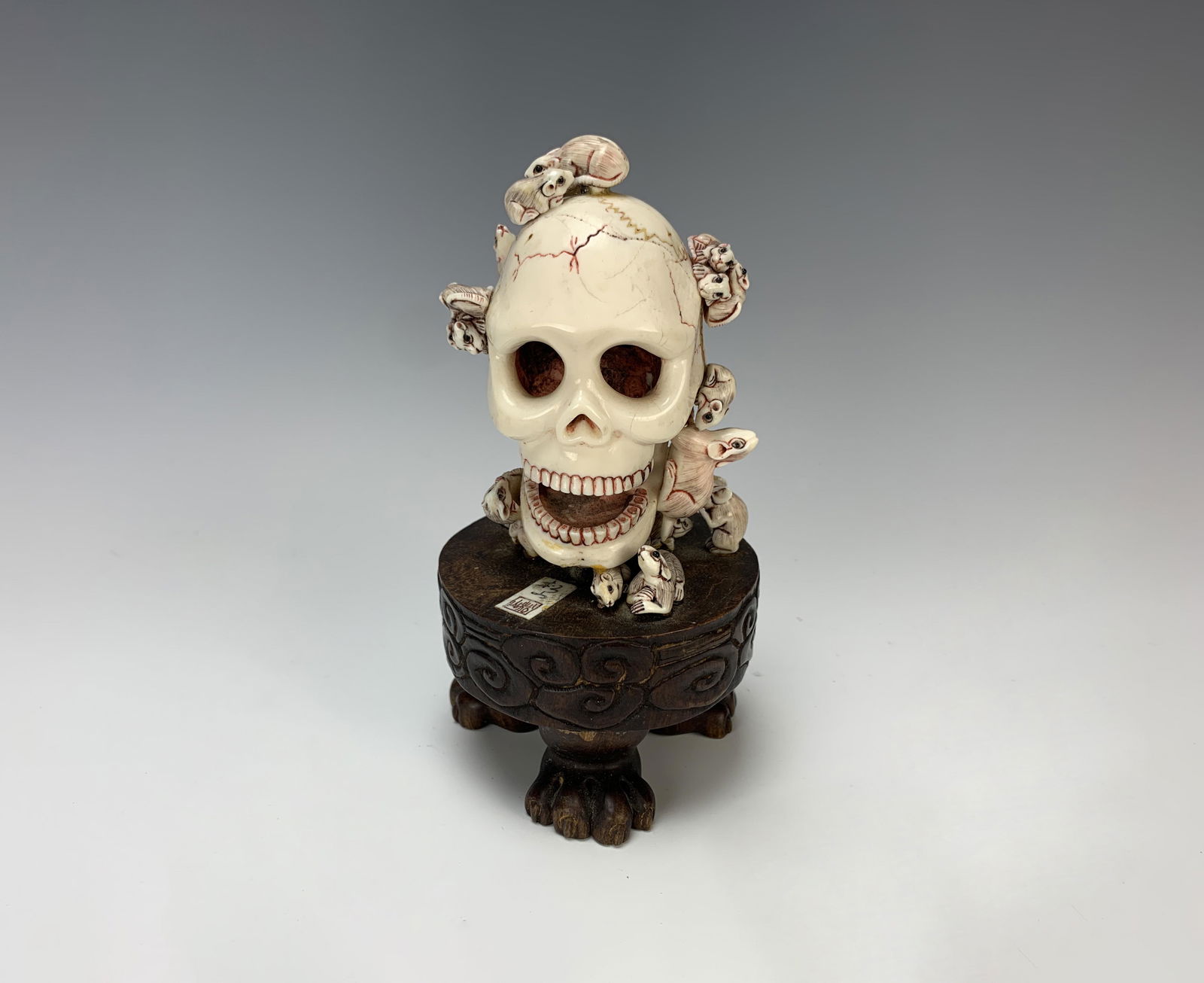 Large Sgd Carved Skull Netsuke w Rats: Signed with chop mark, a large carved netsuke (walrus?) skull surrounded by 18 rats and mounted on a 3 legged stand, 6.5" tall, very good condition.Have a similar item to sell? Email us at info@treasu
