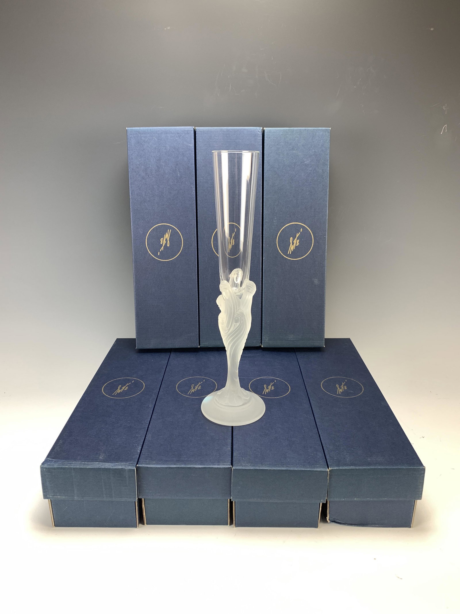 Set of 8 Erte Flute Majestique Champagne Flutes: Set of 8 Erte "Flute Majestique" oversized champagne flutes with frosted stems and clear crystal bulbs portraying seven faces of women symbolizing their roles in society . Roles are Friend, Lover, Con