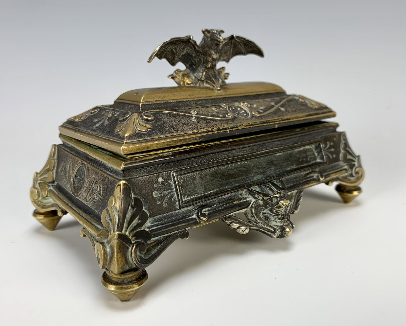 Rare Antique Bronze Bat Figural Match Box: Circa 1880, most likely Austrian, a wonderful and rare box for matches, two tone silvered bronze and bronze with bat having outspread wings and a lion's head all surrounded by decorative designs, insi