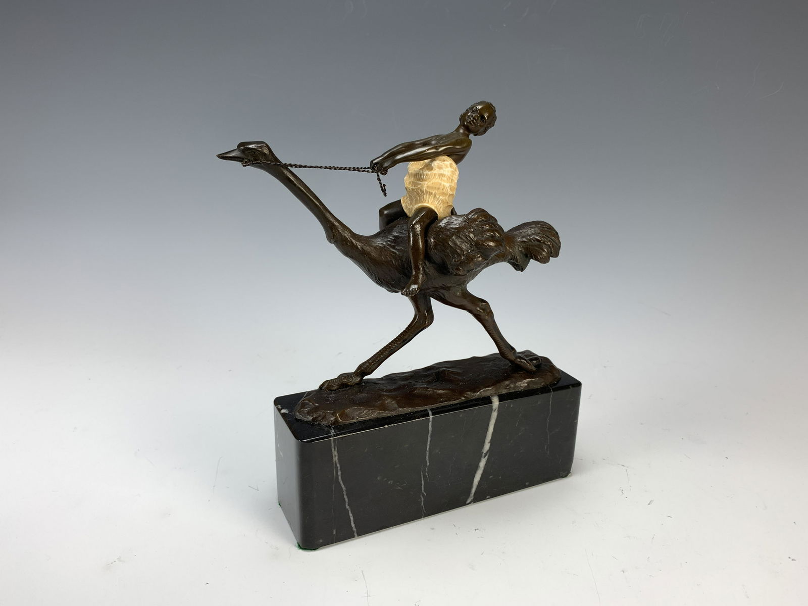 Hans Keck Art Deco Austrian Bronze Sculpture: Hans Keck (1875-1941) "The Ostrich Ride", circa 1925, amusing figural art deco Austrian bronze sculpture having a rich dark brown patina, the female rider wearing a cold painted white garment, signed