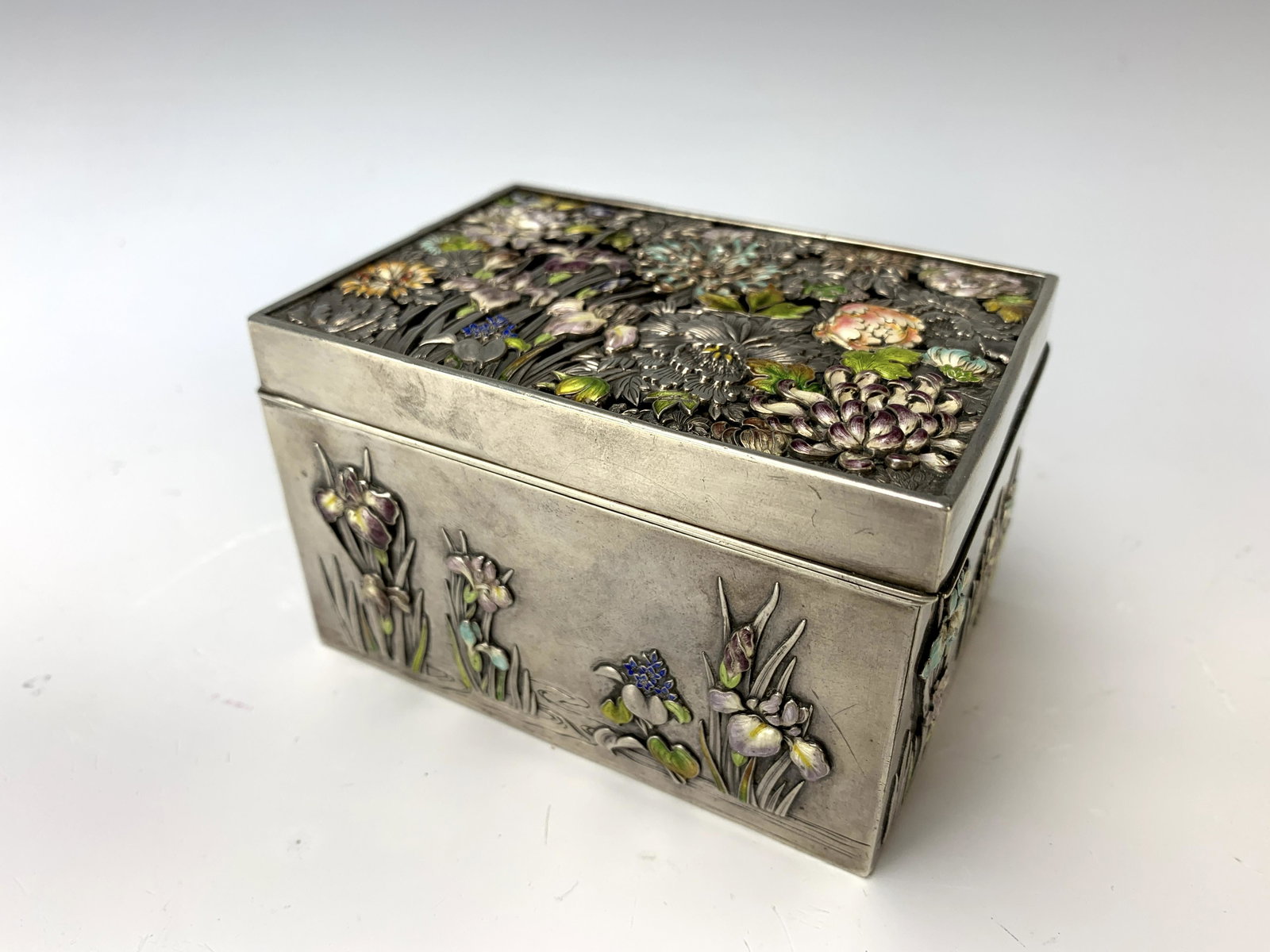 Meiji Period Japanese Silver & Enamel Floral Box: A silver box with enamel decoration on each panel, Meiji period (1868-1912), 4" x 2.75" x 2.5", good condition. Notice: This item was sold in our last auction, Feb 26th 2023 to a Mr. Long Tran, who ne